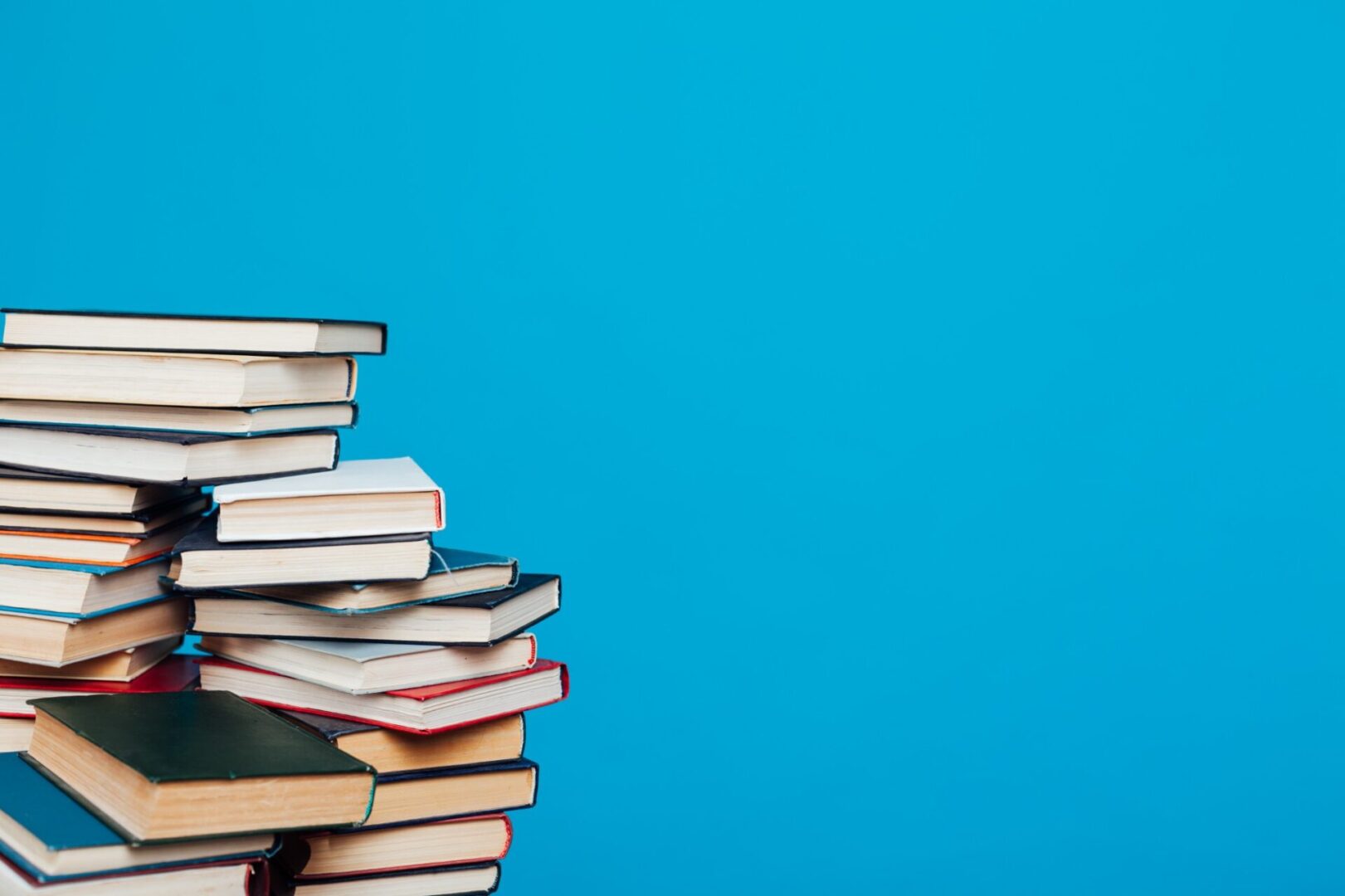 Stack of books against a blue background.